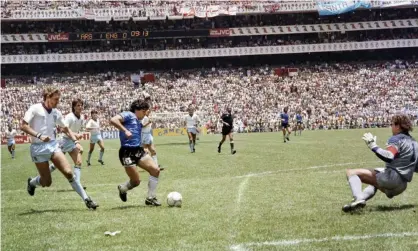 ?? Photograph: STAFF/AFP/Getty Images ?? Diego Maradona scores his second goal against England in the 1986 World Cup final.