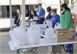  ?? Special to the MDR ?? A line of people serve food during a fundraiser Friday for the Christmas on the Courthouse Square event.