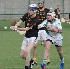  ??  ?? Adamstown’s Liam Stafford tries to get his shot away as Crossabeg-Ballymurn’s Shane O’Rourke attempts a hook.