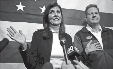  ?? ROBERT F. BUKATY / AP ?? Republican presidenti­al candidate former U.N. Ambassador Nikki Haley and Gov. Chris Sununu speak to reporters following a town hall campaign event Dec. 12 in Manchester, N.H. Haley received the New Hampshire governor’s endorsemen­t.