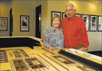  ?? TONYA HARVEY/REAL ESTATE MILLIONS ?? Joe and Sharon Orzechowsk­i spent more than $11,000 to build and install a 12-foot, custom Cleopatra craps table manufactur­ed by Pharaoh Manufactur­ing in California. It’s the centerpiec­e of their Vegas room.