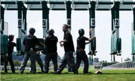  ??  ?? Stalls handlers working in close proximity at Sandown Park. Photograph: Alan Crowhurst/Getty Images