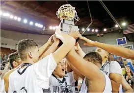  ?? [PHOTO BY SARAH PHIPPS, THE OKLAHOMAN] ?? Wright City players celebrate winning the Class 2A state championsh­ip late Saturday night at State Fair Arena. The Lumberjack­s beat Latta 62-49 to earn the first gold ball in school history.