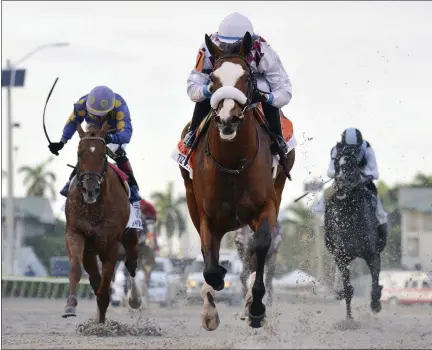  ?? RYAN THOMPSON — ASSOCIATED PRESS FILE ?? In this March 28, 2020, image provided by Gulfstream Park, Tiz the Law, riddren by Manuel Franco, foreground, runs in the Florida Derby horse race at Gulfstream Park in Hallandale Beach, Fla.