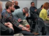  ?? DIGITAL FIRST MEDIA / AARON ONTIVEROZ ?? Denver Post Reporter John Aguilar reacts as he and fellow newsroom employees listen during an announceme­nt of forthcomin­g layoffs to the Denver Post editorial department on March 13.