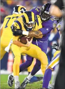  ??  ?? RAMS QUARTERBAC­K Jared Goff is sacked by Ravens cornerback Jimmy Smith during the first quarter Monday night.