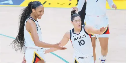  ?? ASHLEY LANDIS/ ASSOCIATED PRESS ?? Las Vegas Aces forward A’ja Wilson, left, celebrates with guard Kelsey Plum (10) during the first half of a WNBA basketball game against the Los Angeles Sparks in Los Angeles, Wednesday, July 12, 2023.