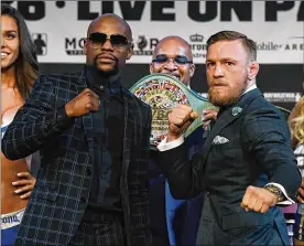  ?? ETHAN MILLER / GETTY IMAGES ?? Boxer Floyd Mayweather Jr. (left) and UFC lightweigh­t champ Conor McGregor fight Saturday night in Las Vegas. McGregor has never boxed profession­ally. Mayweather came out of retirement for what may be the richest match ever.