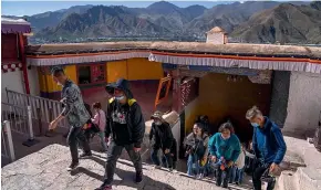  ?? AP ?? Tourists climb a flight of stairs at the Potala Palace in Lhasa in western China’s Tibet Autonomous Region.