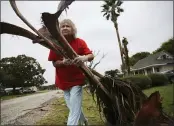  ?? ELIZABETH CONLEY — HOUSTON CHRONICLE ?? Alfa Alamia cleans up her brother’s yard in Palacios, Texas, following Hurricane Nicholas on Tuesday.