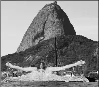  ??  ?? French artist JR shows a print of an athlete swimming in Rio de Janeiro’s Guanabara Bay, on Aug 6, 2016.