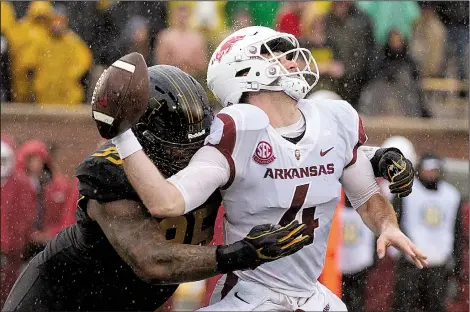  ?? AP/L.G. PATTERSON ?? Arkansas quarterbac­k Ty Storey (4) fumbles as he is sacked by Missouri defensive lineman Jordan Elliott during the first half of Friday’s game at Faurot Field in Columbia, Mo. Missouri’s Akial Byers (Fayettevil­le) recovered the fumble in the end zone for a touchdown.