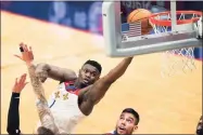  ?? Gerald Herbert / Associated Press ?? New Orleans Pelicans forward Zion Williamson (1) goes to the basket in the first half of an NBA game against the Boston Celtics in New Orleans on Sunday. Williamson was selected to his first All-Star Game on Tuesday.