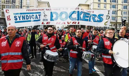  ??  ?? Industrial march: Port workers demonstrat­ing in the harbour city of Le Havre in northern France. — AFP