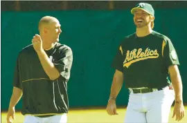  ?? AP FILE PHOTO ?? Athletics pitchers Tim Hudson, left, and Barry Zito share a laugh during pregame activity before a 2003 game at Oakland. They’re among 11 newcomers on the 2021 HOF ballot.