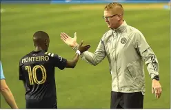  ?? GROUP PETE BANNAN — MEDIANEWS ?? Philadelph­ia Union coach Jim Curtin, right, high-fiving with Jamiro Monteiro after the club’s regularsea­son finale last year, is back for his seventh preseason in charge with a largely intact roster.