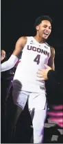  ?? Jessica Hill / Associated Press ?? UConn’s Jalen Adams is greeted by fans as he is introduced during UConn’s men’s and women’s First Night celebratio­n Friday in Storrs.