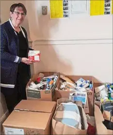  ?? Provided photo ?? Clare Carroll, a parishione­r at All Saints Catholic Church in Albany, organizes medical supplies for Ukrainian relief. The church hosted a Sunday service of music, prayer, Ukrainian poems shared in English, and donation collection­s.