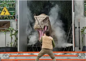  ?? (CONTRIBUTE­D FOTO) ?? THE MIGHTY T. REX at Jurassic World: Roar! A 15-minute liveaction show on the Hollywood Lagoon Stage.