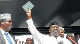  ?? /Reuters ?? Not quite president: Kenyan opposition leader Raila Odinga of the National Super Alliance holds a Bible as he takes a symbolic presidenti­al oath of office in Nairobi on January 30.