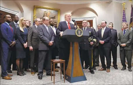  ?? Olivier Douliery Abaca Press ?? PRESIDENT TRUMP, joined by lawmakers and law enforcemen­t representa­tives, announces his support for the criminal justice bill.