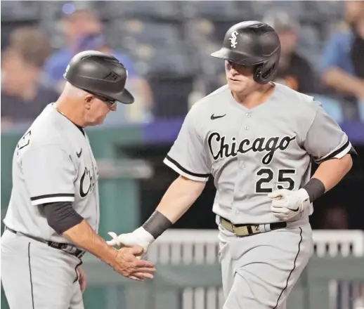  ?? CHARLIE RIEDEL/AP ?? Sox designated hitter Andrew Vaughn is congratula­ted by third-base coach Eddie Rodriguez after hitting a two-run home run in the sixth inning.