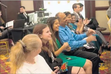  ??  ?? FUTURE USC students Annalise Pasztor and Aarya Suryavansh­i, sitting with their families, laugh during Nikias’ keynote speech. USC is campaignin­g to raise $6 billion for scholarshi­ps, faculty hiring and building.