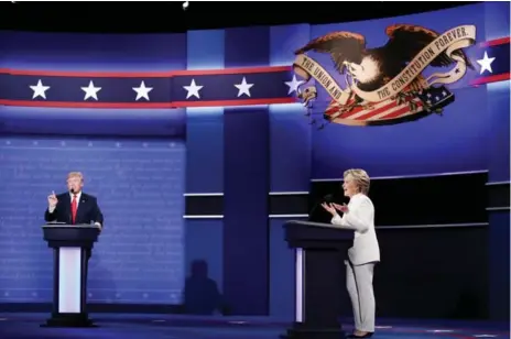  ?? WIN MCNAMEE/GETTY IMAGES ?? U.S. presidenti­al nominees Donald Trump and Hillary Clinton attempt to speak over the other during Wednesday’s last debate.