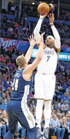  ?? [PHOTO BY NATE BILLINGS, THE OKLAHOMAN] ?? Oklahoma City’s Carmelo Anthony shoots as Denver’s Mason Plumlee defends during Monday’s game at Chesapeake Energy Arena in Oklahoma City. The Thunder won, 95-94.