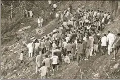  ?? PTI ?? Rescue workers look for survivors after a bus carrying students fell into a gorge near ■ Nurpur in Kangra district of Himachal Pradesh on Monday evening