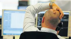  ?? Picture: AFP PHOTO ?? HEADACHE: A trader from ETX Capital in central London after the announceme­nt of the results of the EU referendum. London stocks plunged in early deals on Friday but pared losses