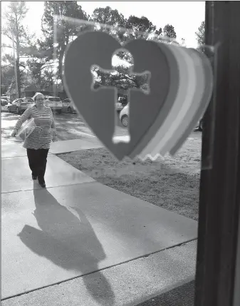  ?? NWA Democrat-Gazette/J.T. WAMPLER ?? Anita Andres, regional director of Reconcilin­gWorks, affiliated with the Evangelica­l Lutheran Church in America, walks Sunday into Good Shepherd Lutheran Church in Fayettevil­le. The church has been certified as a Reconcilin­g in Christ Church, meaning they welcome and accept members of all cultural groups and provide a safe place to worship for those marginaliz­ed by society.