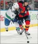  ?? — GETTY IMAGES ?? Ed Jovanovski (right) of the Panthers and Cody Hodgson of the Canucks battle for the puck Jan. 9 at the Bankatlant­ic Center in Sunrise, Fla.