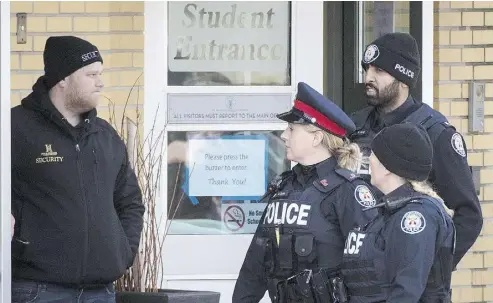  ?? TIJANA MARTIN / THE CANADIAN PRESS ?? Toronto police respond to a bomb threat at St. Michael’s College School in Toronto on Monday, on the same day that six teens from the all-boys private school were charged in connection with an alleged gang sexual assault.