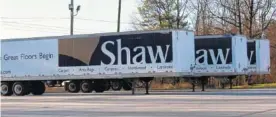  ?? FILE PHOTO ?? Trucks from Shaw Industries, a giant flooring company, are seen in Dalton, Ga.