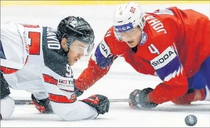  ?? AP PHOTO ?? Canada’s Connor Mcdavid, left, and Norway’s Johannes Johannesen eye the puck during the world hockey championsh­ip Thursday at the Jyske Bank Boxen Arena in Herning, Denmark.