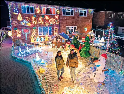  ??  ?? Christmas crackers Tracey and Leeann Clare, two sisters from Lincoln, have decorated their home early to cheer up neighbours. Above: a drive-in