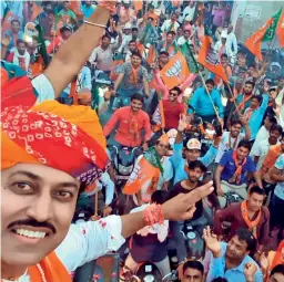  ??  ?? RIDING HIGH ON NATIONALIS­M: Union Minister and the BJP’s Jaipur Rural candidate Rajyavardh­an Rathore takes a selfie with supporters at Renwal in Jaipur district.