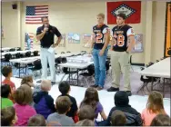  ?? Submitted Photo ?? Bill Harrelson (left), head coach of the Gravette Lions, and Bret Callahan and Hunter Graham, two members of the high school football team, attended this year’s first Rise and Shine assembly at Glenn Duffy Elementary School. Coach Harrelson spoke to...