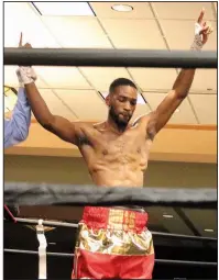  ??  ?? Welterweig­ht boxer Demarcus Layton captures the title belt in the Main Event.