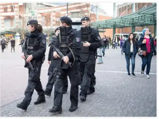  ??  ?? Police officers walk near Centro mall in Oberhausen, Germany, on Saturday. (AP)