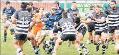  ??  ?? Referee Rebecca Mahoney (in orange) gets amongst it during Saturday’s Wanganui vs Hawke’s Bay at Spriggens Park.