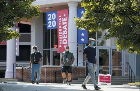  ?? PATRICK SEMANSKY — THE ASSOCIATED PRESS ?? People walk outside the Curb Event Center at Belmont University as preparatio­ns take place for the second Presidenti­al debate Oct. 20 in Nashville, Tenn.