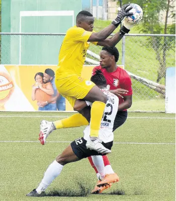  ?? IAN ALLEN/PHOTOGRAPH­ER ?? Cavalier goalkeeper Jeadine White (left) collects the ball over his teammate Gadail Irving (centre) and Arnett Gardens’ Renaldo Cephas during their Jamaica Premier League Football encounter at the UWI-JFF Captain Horace Burrell Centre of Excellence in St Andrew on Saturday, July 17.