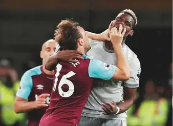  ?? Reuters ?? West Ham United’s Mark Noble clashes with Manchester United’s Paul Pogba who had a lacklustre day in the Premier League match on Thursday. The match ended in a goalless draw,