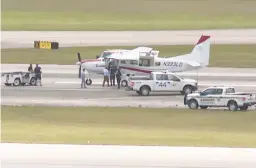  ?? WPTV ?? Emergency personnel surround a Cessna plane May 10 at Palm Beach Internatio­nal Airport in West Palm Beach, Fla., after a passenger with no experience was able to land it safely.