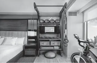  ?? Hilton Hotels ?? Fitness equipment comes with this Hilton hotel room. Wellness vacations now extend beyond traditiona­l massages and spa treatments as travelers seek a way to heal from physical and mental stress brought on by a pandemic that seems unending.