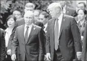  ?? Jorge Silva AFP/Getty Images ?? PRESIDENT TRUMP talks with Russian President Vladimir Putin in Vietnam on Nov. 11.