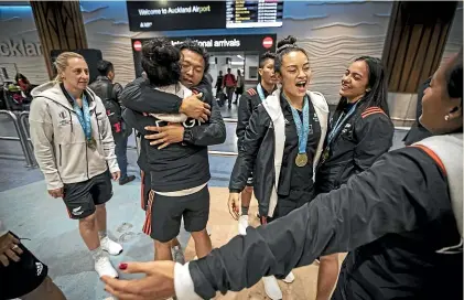  ??  ?? The New Zealand women’s sevens team was welcomed home in Auckland yesterday by family and friends after their World Cup win in San Francisco on Sunday. LAWRENCE SMITH/STUFF
