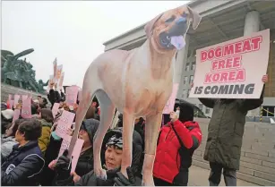  ?? AHN YOUNG-JOON/THE ASSOCIATED PRESS ?? Animal rights activists attend a protest rally supporting the government-led bill banning dog meat Tuesday at the National Assembly in Seoul, South Korea.